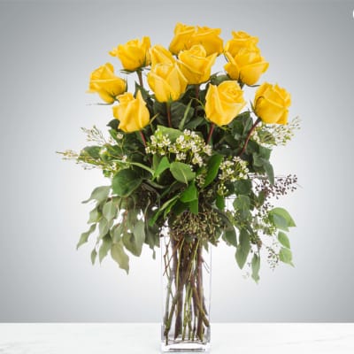 Yellow roses arranged in a clear glass vase