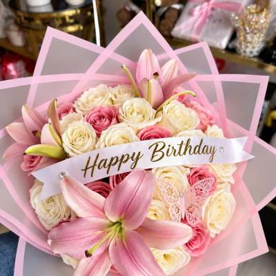 Pink and white rose bouquet with lilies and a Happy Birthday ribbon