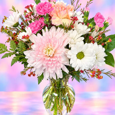 Pink and white mixed bouquet in a clear glass vase
