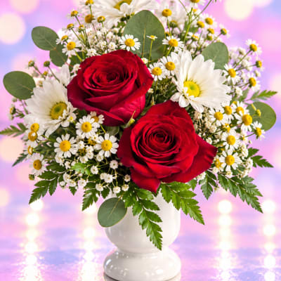 Red roses and white daisies in a white vase