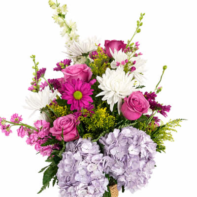 Pink and white mixed bouquet in a magenta glass vase