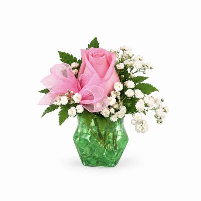 Pink rose arrangement in a green glass vase with white filler flowers