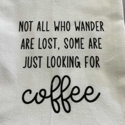 White fabric with black quote text about coffee