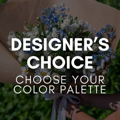 Handheld bouquet of blue and white flowers wrapped in brown paper