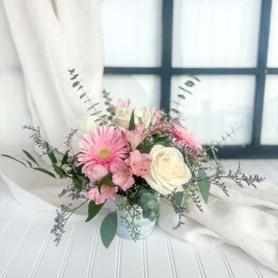 Pink and white bouquet in a small white vase