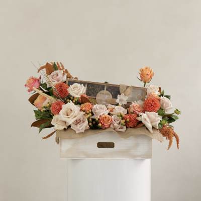 Mixed rose arrangement in a wooden box with a tea gift set