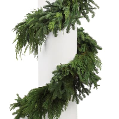 Green evergreen garland wrapped around a white column