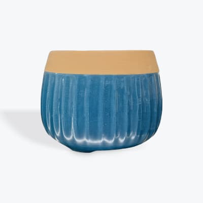 Blue and tan ceramic planter or bowl on a white background