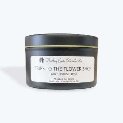 Black candle tin with a flower shop label