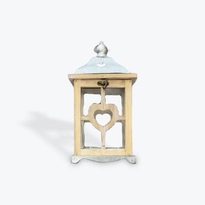 Decorative wooden lantern with a heart cutout and metal top