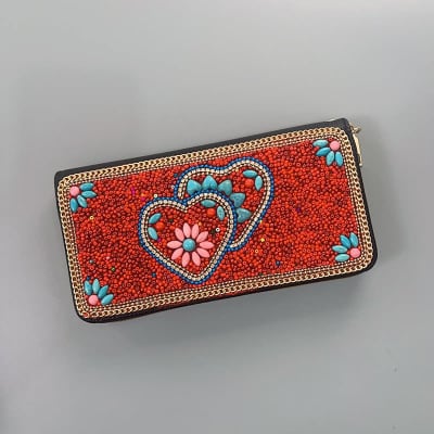 Beaded red clutch with heart and flower designs