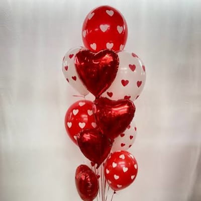 Cluster of red and white heart-shaped balloons tied together