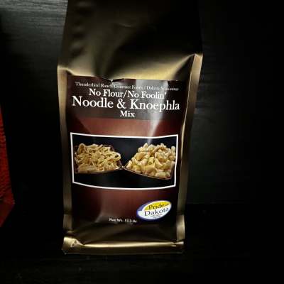 Bag of noodle and knoephla mix on a dark surface