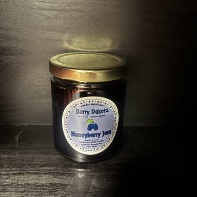 Jar of honeyberry jam with a gold lid