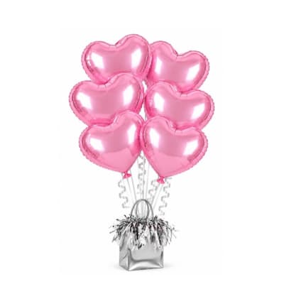 Cluster of pink heart-shaped balloons in a silver gift bag
