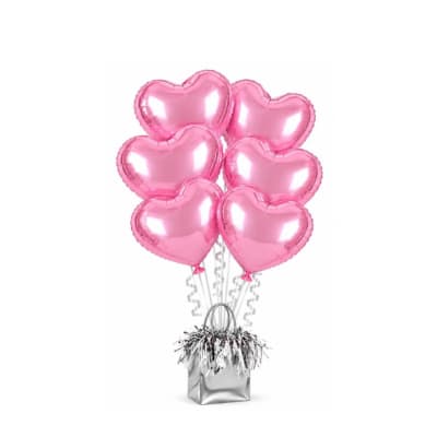 Pink heart-shaped balloons in a silver gift bag with curly ribbons