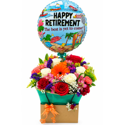 Retirement balloon above a colorful flower arrangement in a gift bag
