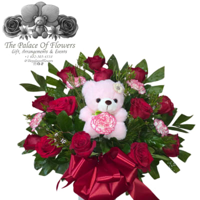 Bouquet of red roses with a pink teddy bear and satin ribbon