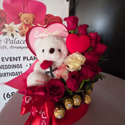 Heart-shaped rose arrangement with a teddy bear and chocolates