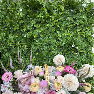 Basket arrangement of pink and white flowers with a gift box and ribbon