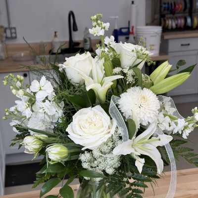 White floral bouquet in a clear glass vase