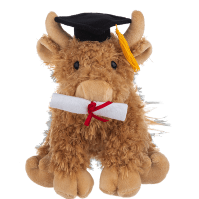 Brown plush cow wearing a graduation cap and holding a rolled diploma with red ribbon