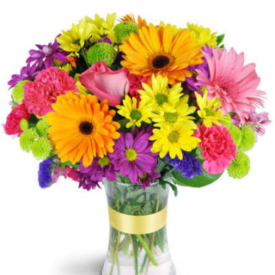 Colorful mixed bouquet in a clear glass vase with a yellow ribbon