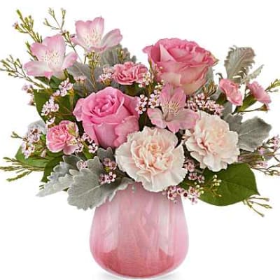 Pink roses and carnations in a pink glass vase