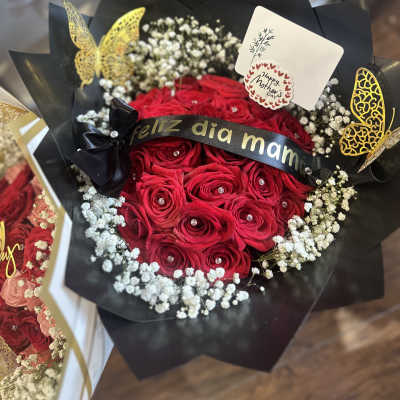 Red rose bouquet with baby's breath and a Mother's Day card