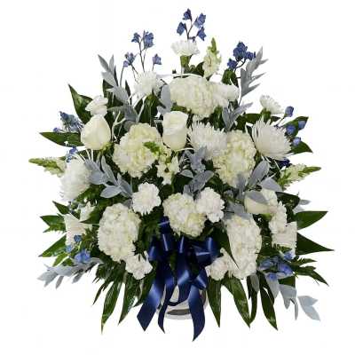 White floral spray with blue accents and a navy ribbon