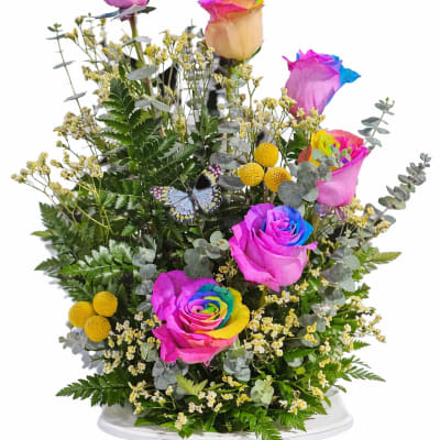 Rainbow-tinted roses in a white vase with a butterfly decoration