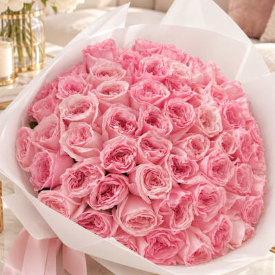 Bouquet of pink roses wrapped in white paper