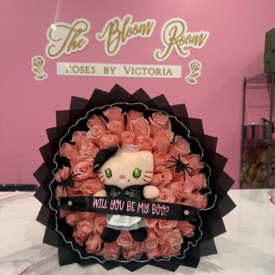 Pink rose bouquet with a Hello Kitty plush and a "Will you be my boo?" ribbon