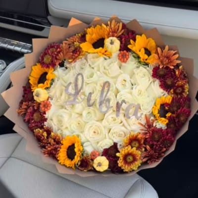 Round bouquet of white roses with sunflowers and burgundy mums