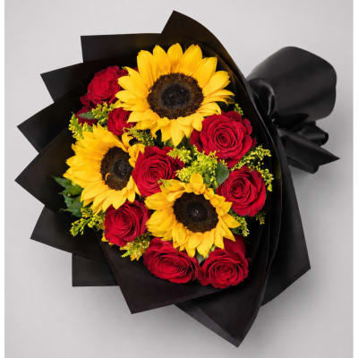 Bouquet of red roses and yellow sunflowers wrapped in black paper