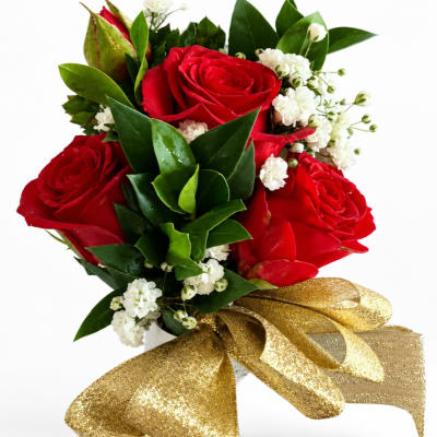 Red roses with white filler flowers and a gold ribbon bow