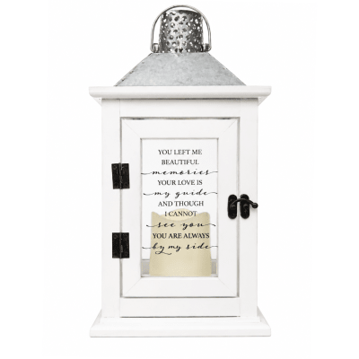 White decorative lantern with a memorial quote on the front