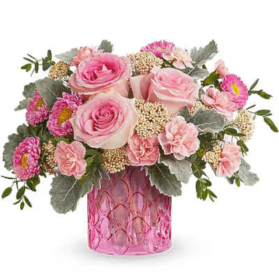 Pink roses and carnations in a pink glass vase