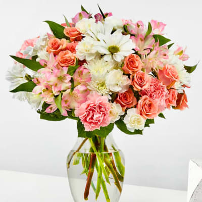 Bouquet of pink and white flowers in a clear glass vase