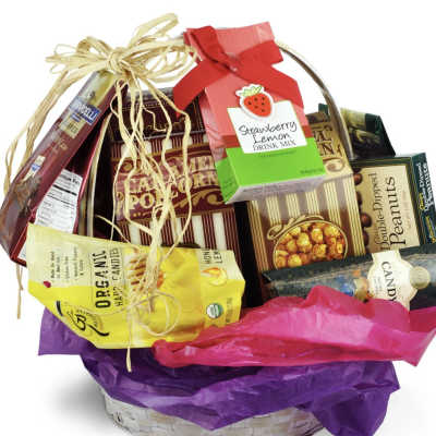 Basket of assorted candy and drink mix gift items with ribbon