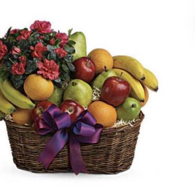 Fruit basket with red flowers and a purple ribbon