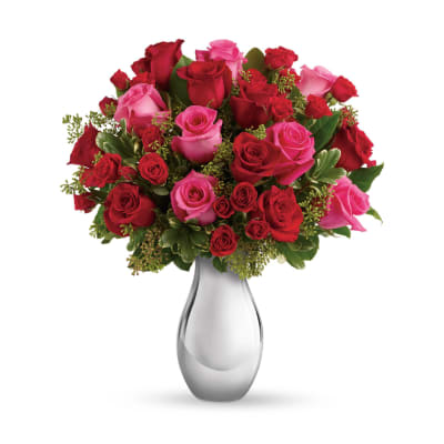 Bouquet of red and pink roses in a clear glass vase