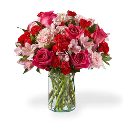 Pink and red mixed bouquet in a clear glass vase
