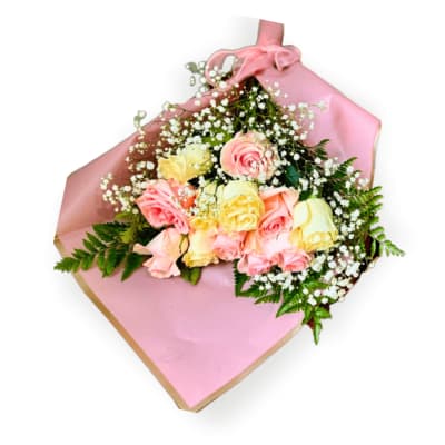 Bouquet of pink and yellow roses wrapped in pink paper