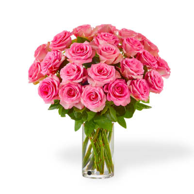 Pink roses arranged in a clear glass vase