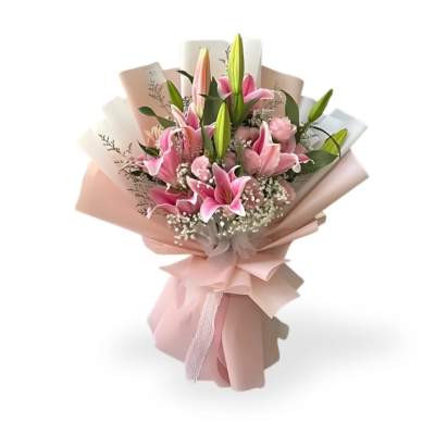 Pink lily bouquet wrapped in blush paper with a ribbon