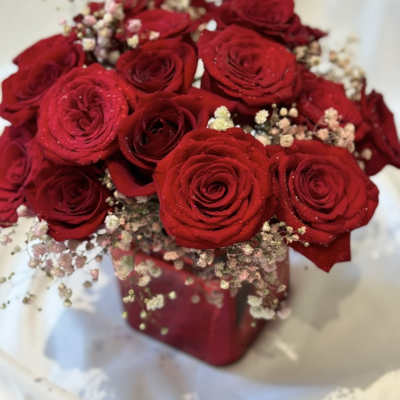 Bouquet of red roses with baby's breath in a red wrap