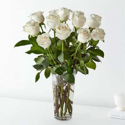 White roses arranged in a clear glass vase