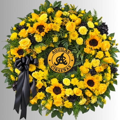 Yellow floral wreath with sunflowers, roses, and a black ribbon
