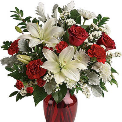 Red roses and white lilies in a red glass vase
